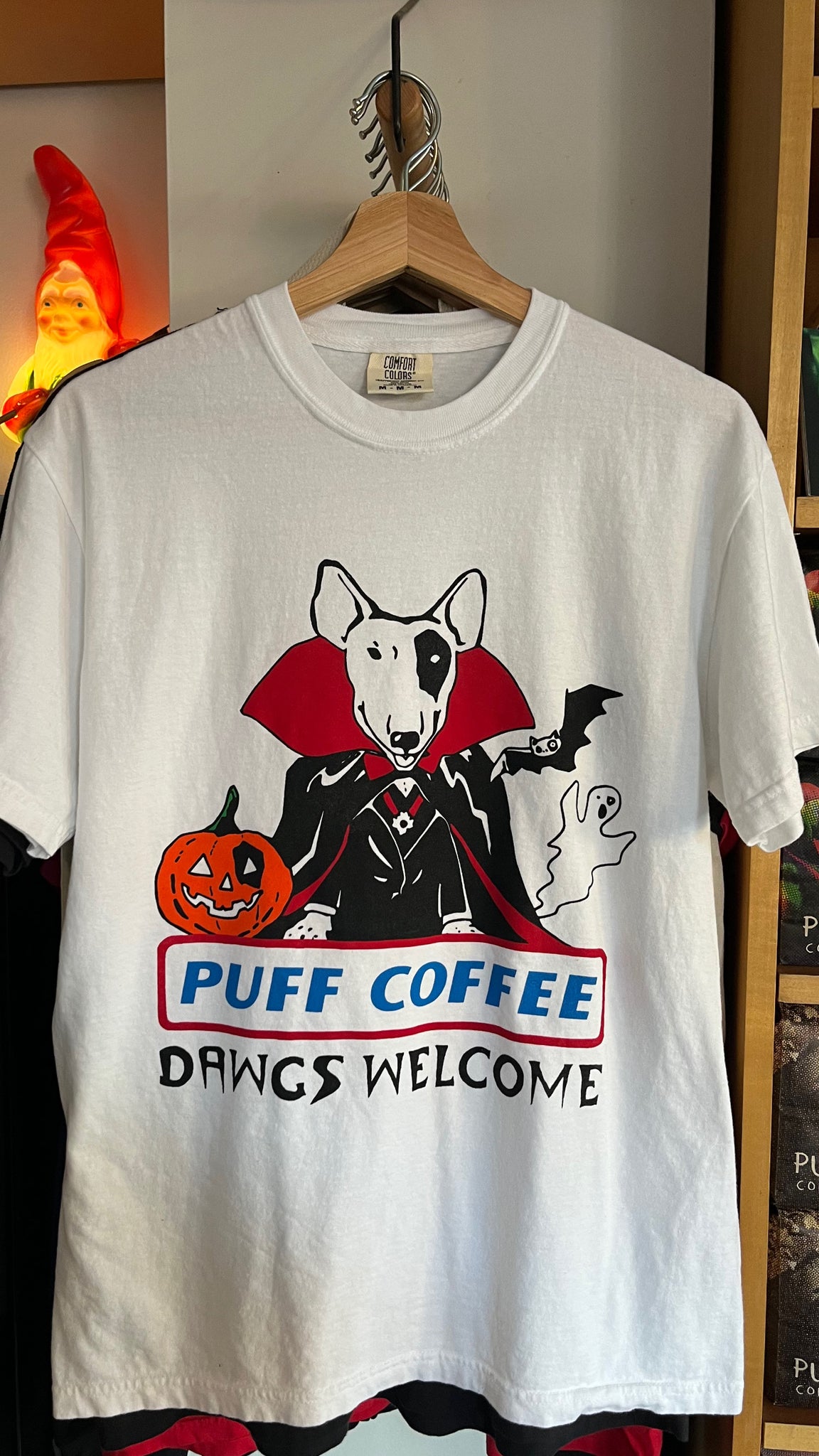 Halloween graphic tee motif featuring dracula dog, ghost and pumpking with words "puff coffee dawgs welcome" 
